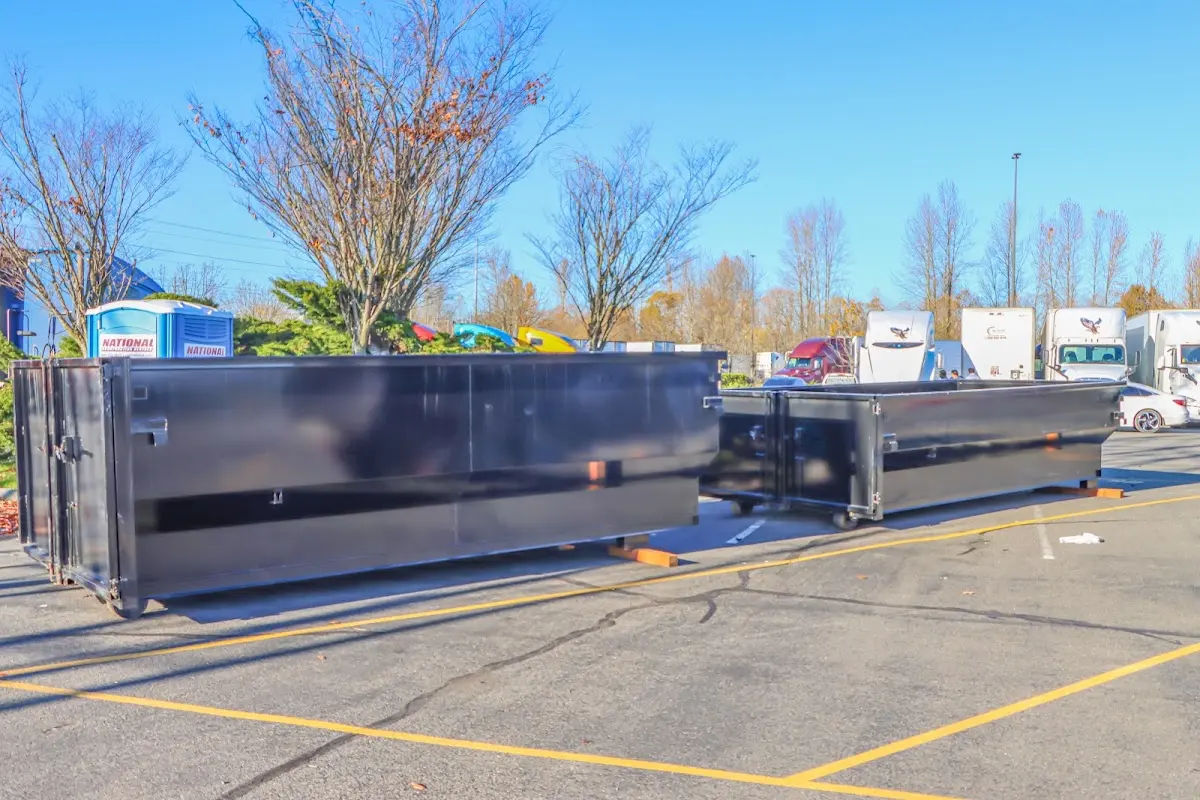 Professional dumpster rental service with roll-off container on residential driveway in Roeland Park